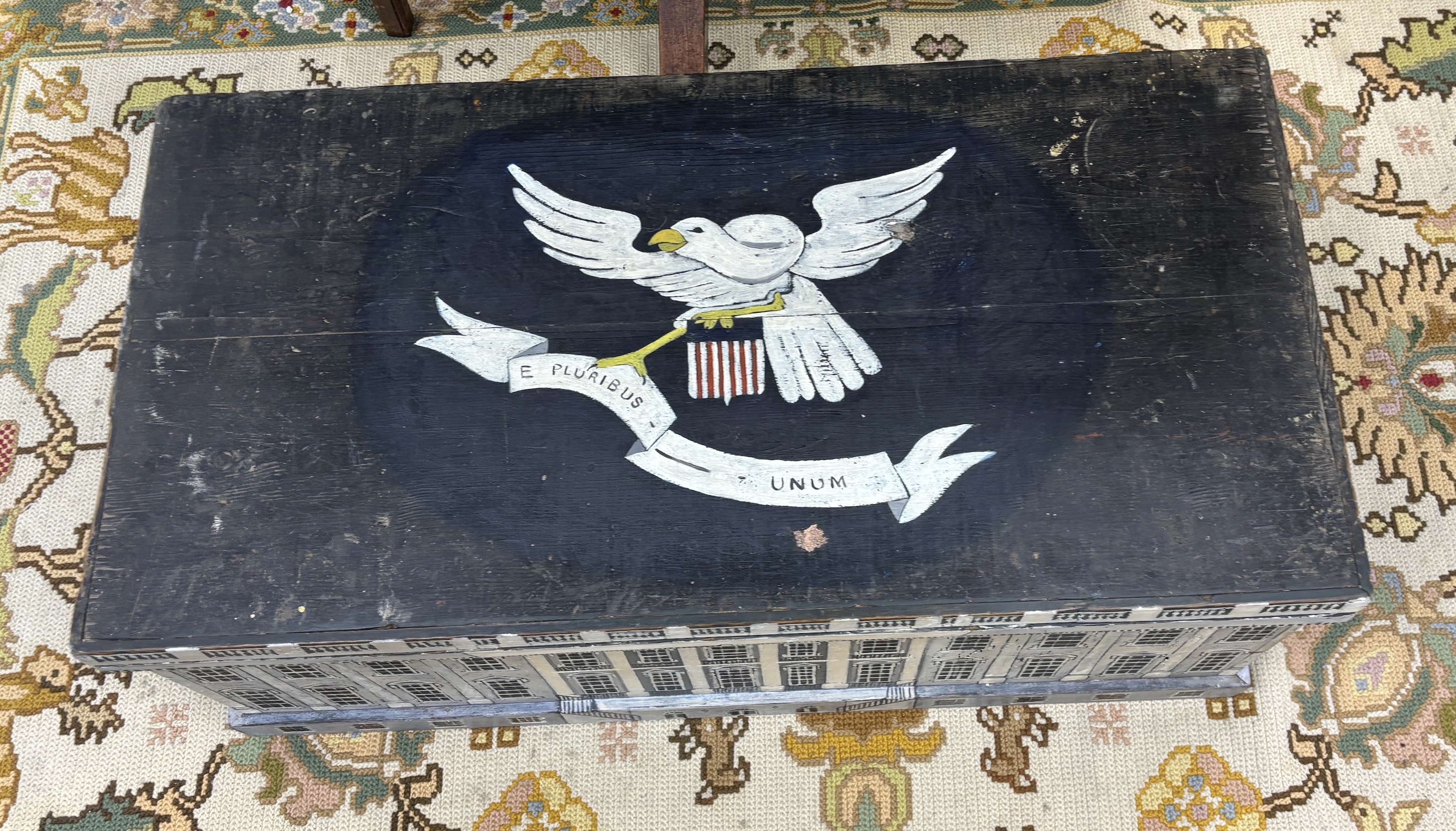 A 19th century pine trunk, later painted with a depiction of The White House and an American crest, width 88cm, depth 46cm, height 34cm